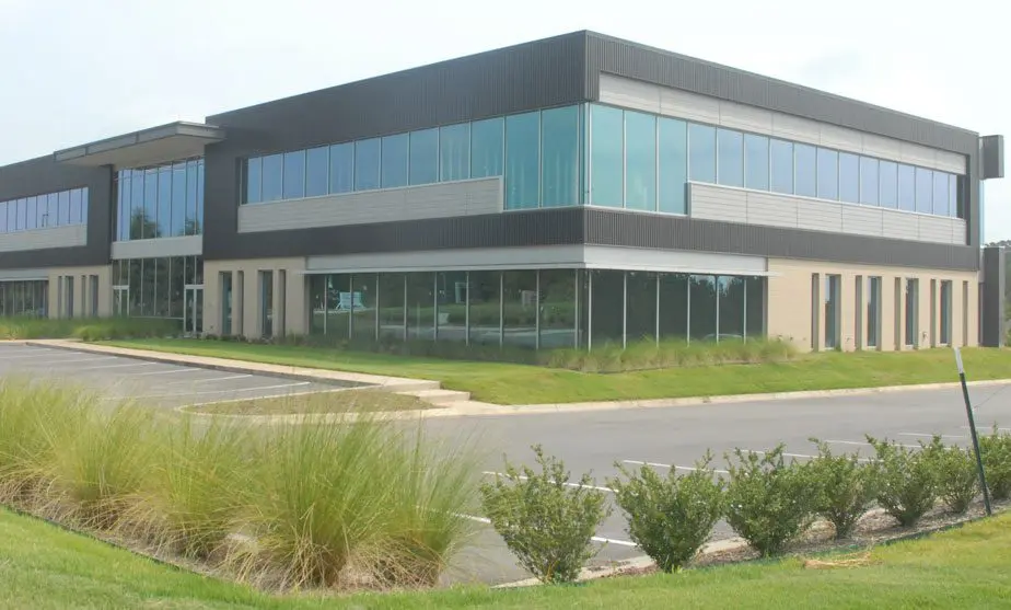 A large building with many windows and grass