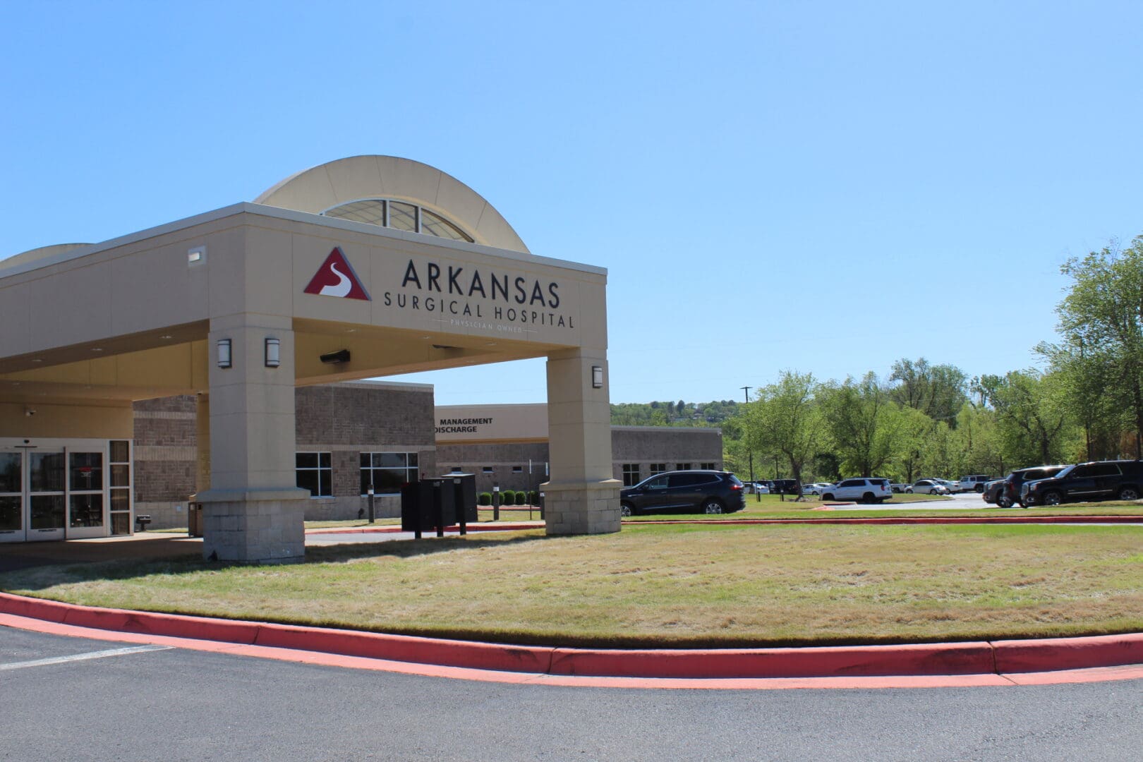 A large building with a parking lot in front of it.