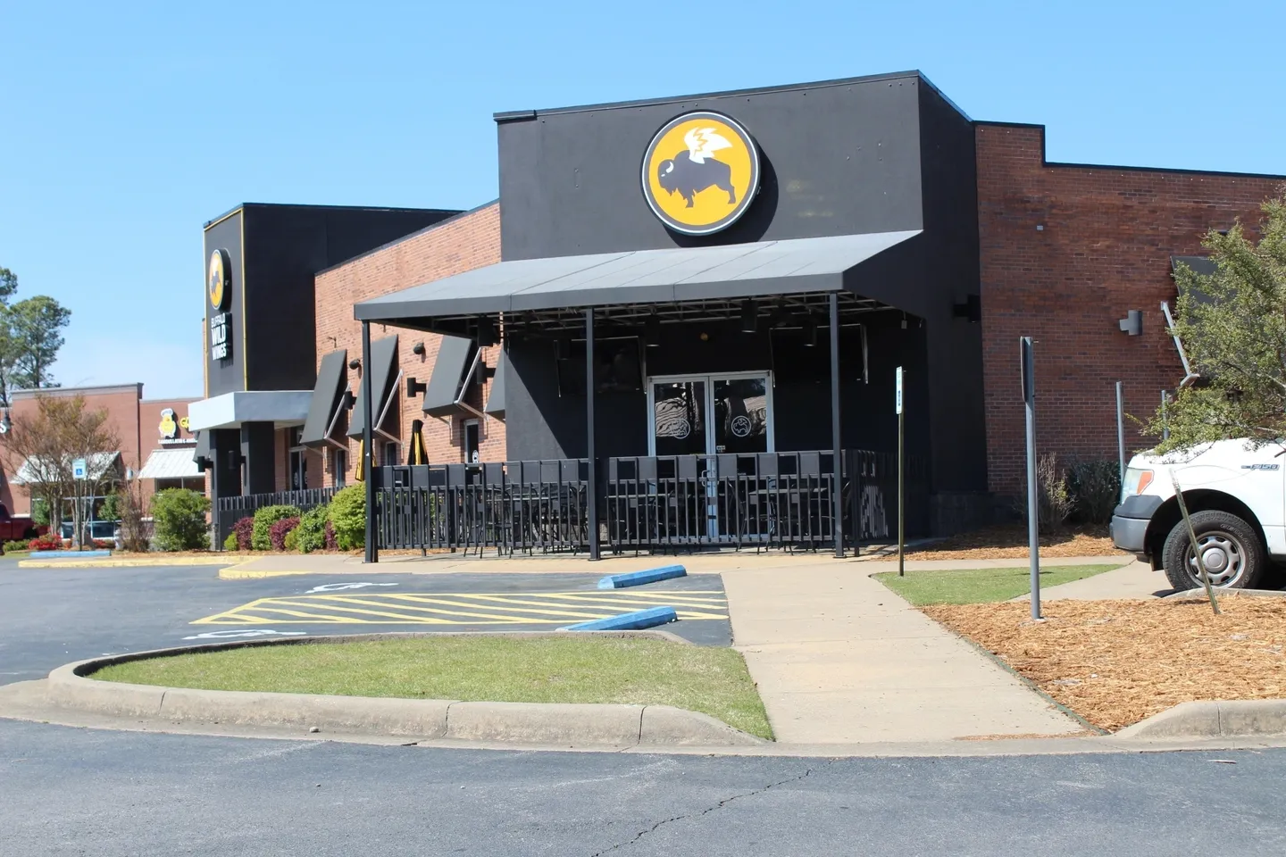 A black and yellow building with a horse logo.